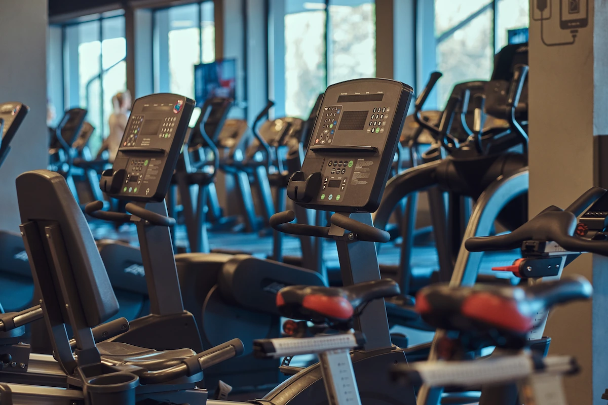 Members on stationary bikes during an indoor cycling class at Muscle Garage